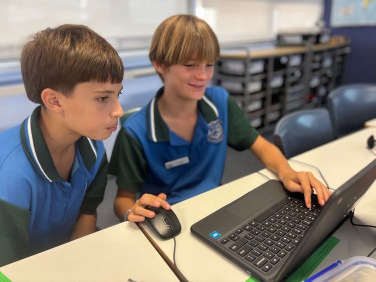 7 of 18 images: two boys on computers:View full sized image